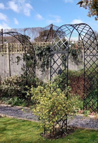 Two Bagatelle Round-Top Garden Arches by Classic Garden Elements installed across garden path