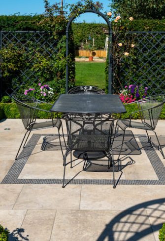 The Portofino Romanesque Garden Arch and Paravent Metal Railing Panel enclosing an outside seating area