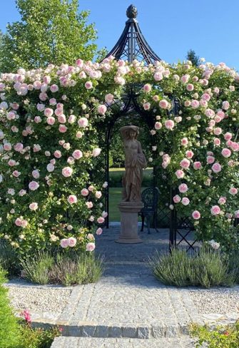 The Schoenbrunn Wrought-Iron Gazebo by Classic Garden Elements with a statue in the middle