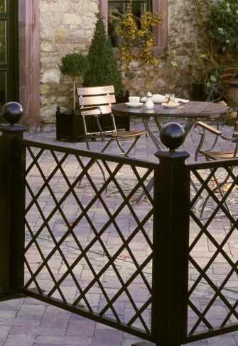 Restaurant Trellis Divider with diamond-shaped latticework enclosing outside terrace