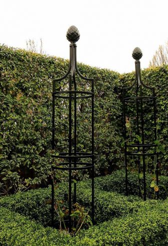 Formal border with a metal Garden Obelisk I by Classic Garden Elements