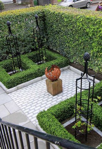 Four Classic Garden Elements garden obelisks in a formal patio garden