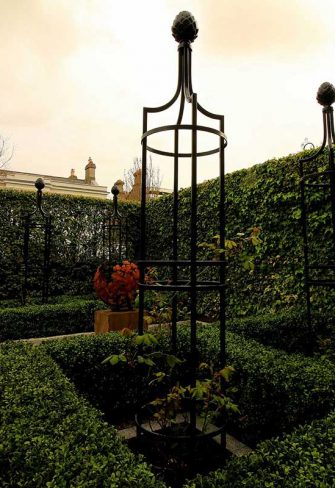 Metal Garden Obelisk I in a patio setting