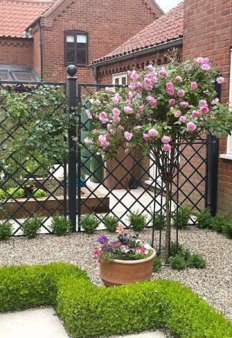 The Giverny Rose Umbrella Support by Classic Garden Elements with pink roses