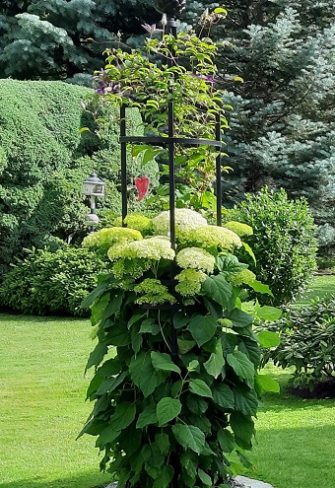 Garden Obelisk I by Classic Garden Elements covered in foliage