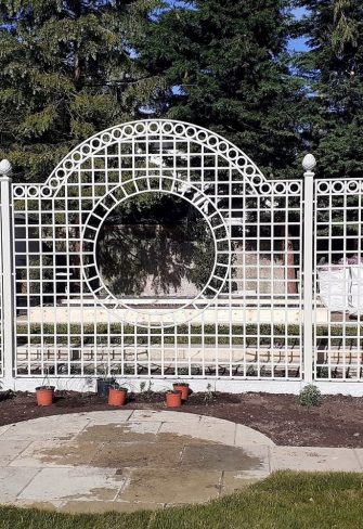 The installation of a Classic Garden Elements Trianon Rose Treillage Set in a garden in Ireland