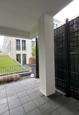 Classic Garden Elements' Gropius Iron Railing Privacy Screen creates privacy on a terrace