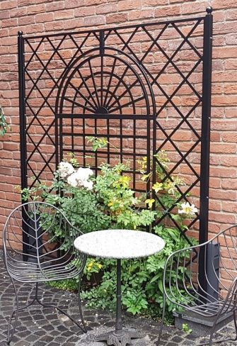 The Orangery Wrought-Iron Railing by Classic Garden Elements, custom-made for use in a courtyard garden