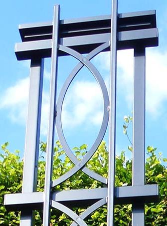 The freestanding Boston Garden Obelisk by Classic Garden Elements against a blue sky