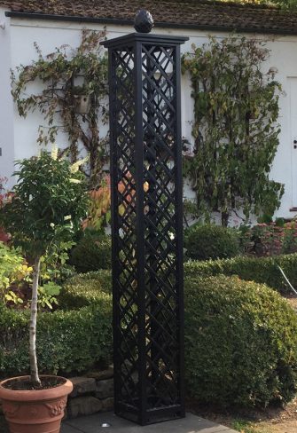 The Wessling Treillage Tower by Classic Garden Elements installed on a patio