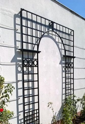 The Osborne House Single Treillage Panel Set by Classic Garden Elements installed on a white wall, seen from the side