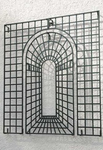 The Houghton Perspective Garden Trellis on a white house façade in the sun