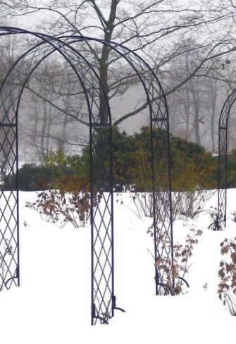 Several Bagatelle Round-Top Garden Arches at the Glücksburg Rosarium on a snowy winter's day