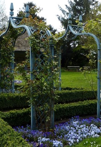 Two blue Brighton Victorian Rose Arches by Classic Garden Elements, in the Blue Garden at Ellerhoop Arboretum in springtime