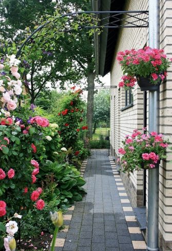 Two Bagatelle Half-Round Garden Arches create an attractive walkway along the side of a house