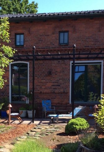 The Piemont Metal Pergola by Classic Garden Elements installed on a terrace